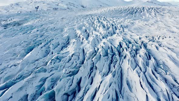 Drone Flight Over Frozen Glacier With Mountains