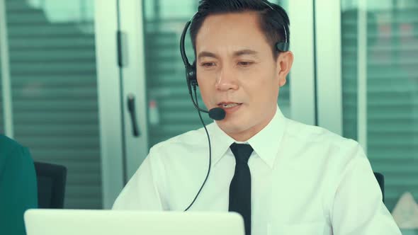 Businessman Wearing Headset Working Actively in Office