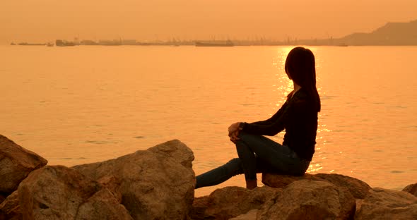 Woman sitting at the seaside