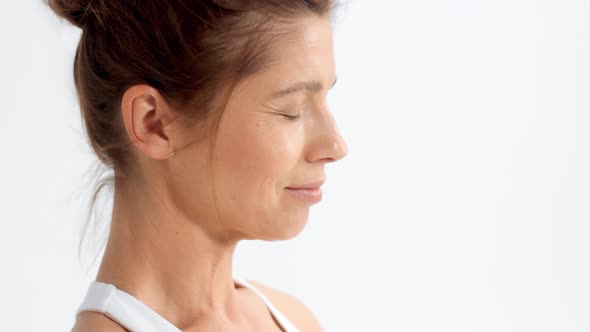 Senior Woman in White Space Practice Yoga