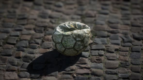 Old Soccer Ball in the Pavement Yard