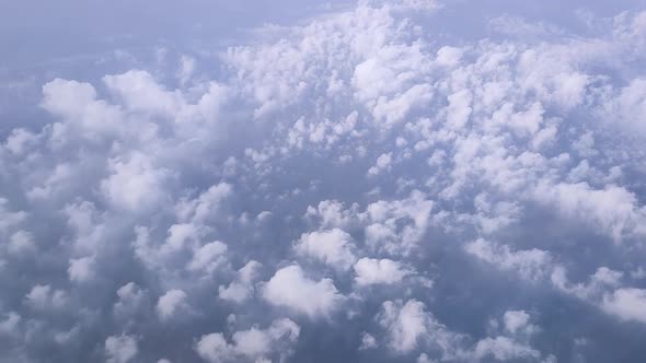 Top View From the Plane to the Sky with Cumulus Clouds in Sunny Weather