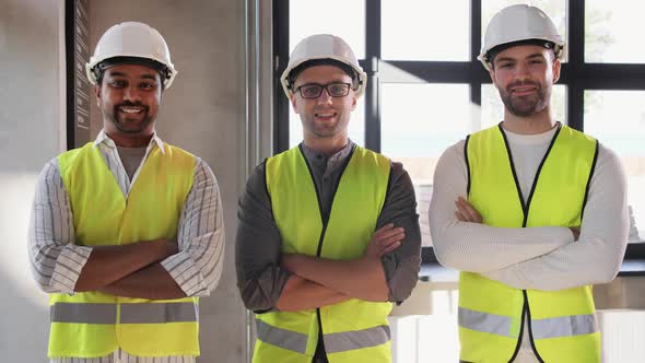 Happy Smiling Male Architects in Helmets at Office