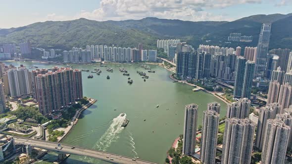 Tsuen Wan waterfront boat traffic with impressive Nina Tower, Hong Kong; aerial