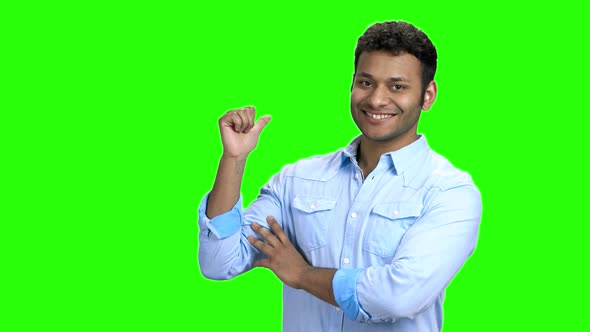 Indian Man Pointing with Thumb at Copy Space