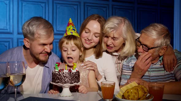 Adorable Child Girl Kid Eating Cake Making Wish Having Fun Celebrating Birthday Party with Family