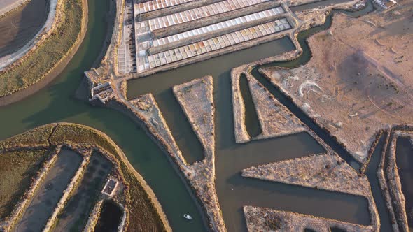 Aerial drone view of salt fields in Portugal. Sunset cinematic shot. Salt extraction.