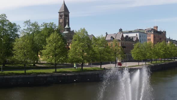 Norrkoping, Sweden, Aerial Rise Up Motala River Fountain And City Hall