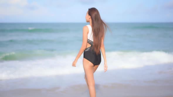 Asian woman enjoy around beautiful beach sea ocean