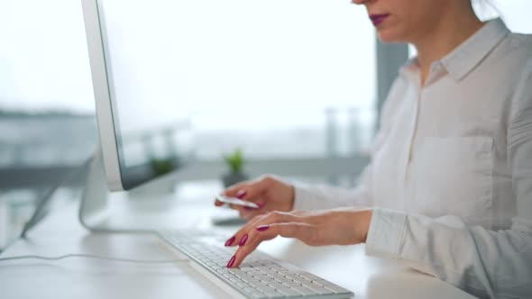 Woman Typing Credit Card Number on Computer Keyboard