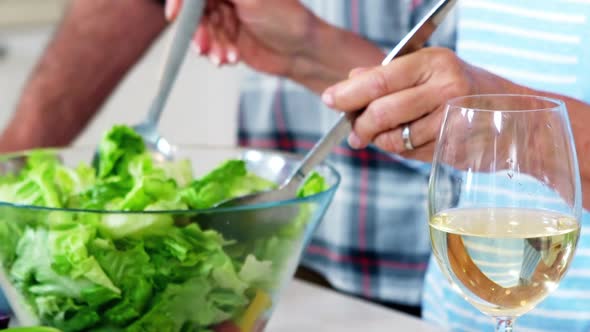 Senior woman preparing vegetable salad