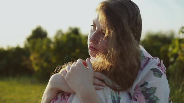 Portrait of Spring Young Lady Sitting Among Nature in Calmness