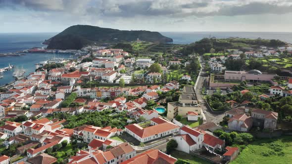 White Painted Buildings Creep Up the Hill Towards a Magnificent Coast