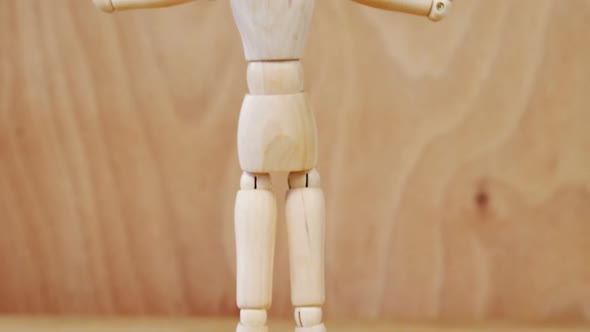 Figurine standing with arms stretched