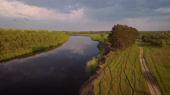 Calm river in the evening lit by setting sun