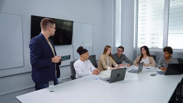 Businessman Giving Presentation to Colleagues in Office