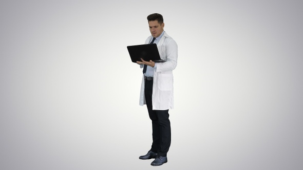 Doctor showing results in laptop on gradient background.