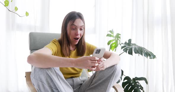 Woman Surfs in Mobile Phone and Surprised Plant Background