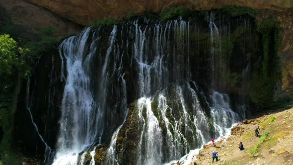 Tourist Relaxing by Waterfall 