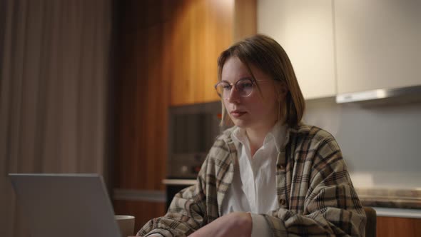 Mature Businesswoman Working From Home Focused Woman is Working with Her Laptop and Paper Documents