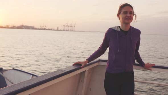 Young Woman Traveling By Boat at Sunset or Sunrise