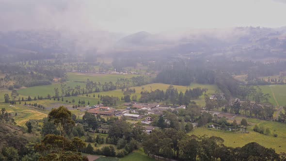 Andes landscape view, with a village surrounded by cultivated fields, at dusk, Ecuador