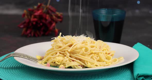 Pecorino cheese on spaghetti alla carbonara