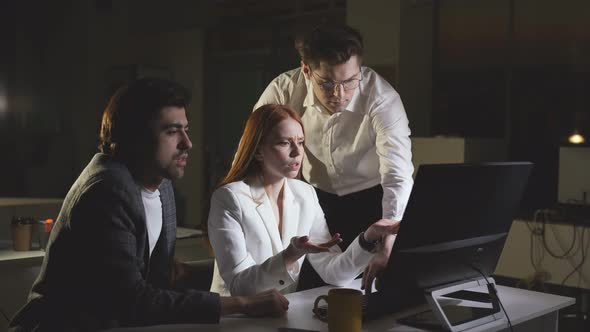 A Hardworking Woman Works Late at the Office with Colleagues