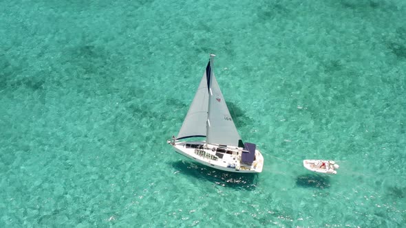 Navigating White Yacht With Small Motorboat On Tropic Islands Of Bahamas During Summer In Florida. -