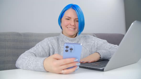 Freelancer girl with colorful hair using modern smartphone in closeup 4k video
