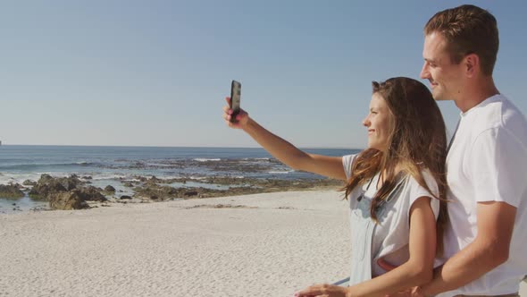 Young adult couple relaxing at the seaside