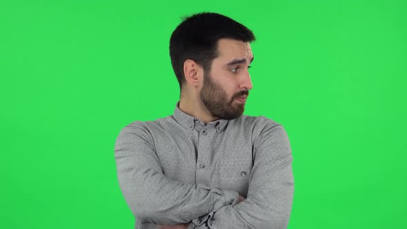 Portrait of Brunette Guy Is Waiting and Angry . Green Screen