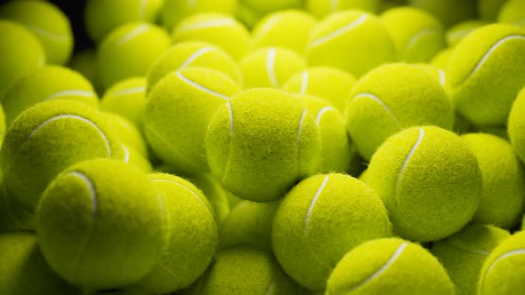 Seamless looping animation.Set of many tennis balls on the black background.