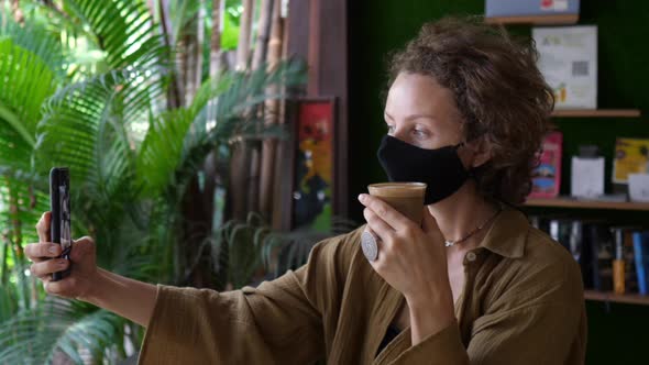 Young Caucasian Woman Taking a Selfie with Her Plant Based Coffee Latte During Her Coffee Break