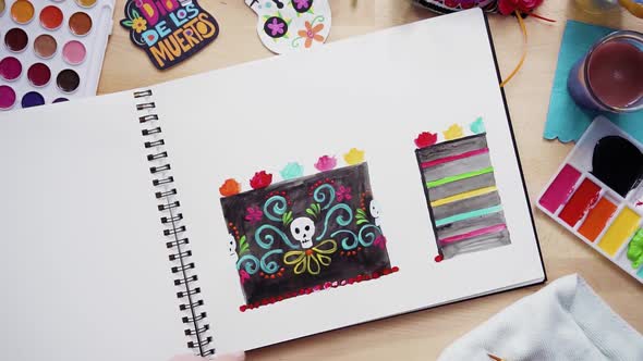 Step by step. Flat lay. Baker sketching a design of a cake with watercolors for Dia de los Muertos h