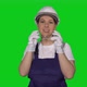 Woman Builder in Blue Overalls and White Hard Hat Put on Protective Glasses - VideoHive Item for Sale