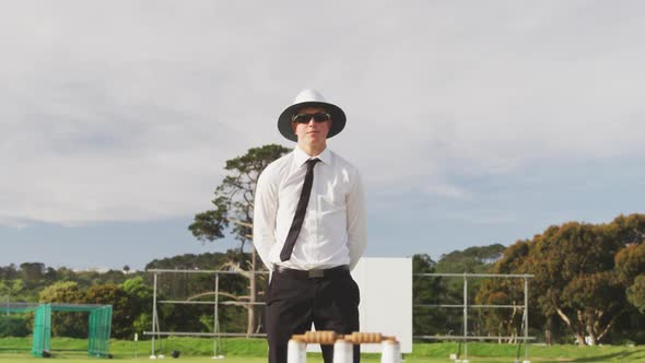 Cricket umpire making signs standing on a cricket pitch