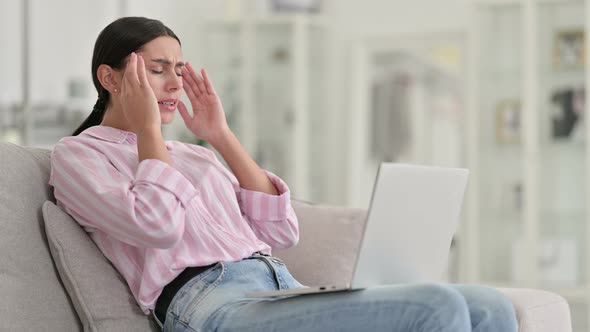 Stressed Young Latin Woman with Laptop Having Headache at Home 