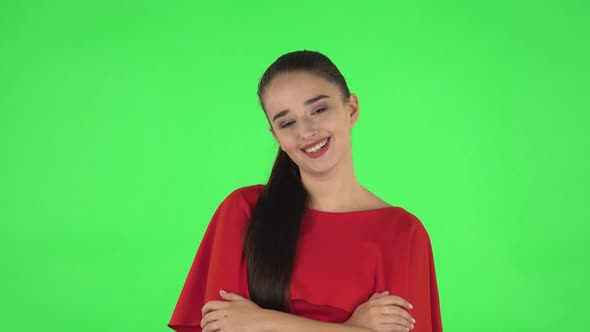 Portrait of Pretty Young Woman Communicates with Someone in a Friendly Manner. Green Screen