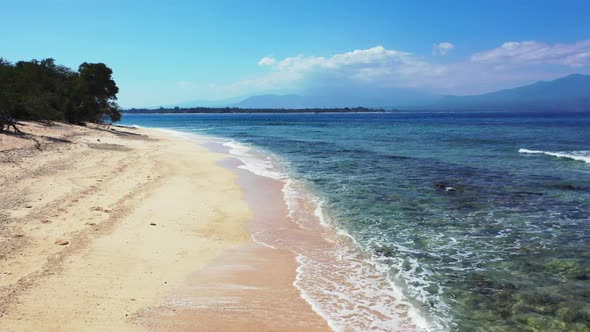 Aerial drone shot travel of perfect tourist beach adventure by clear water with white sandy backgrou