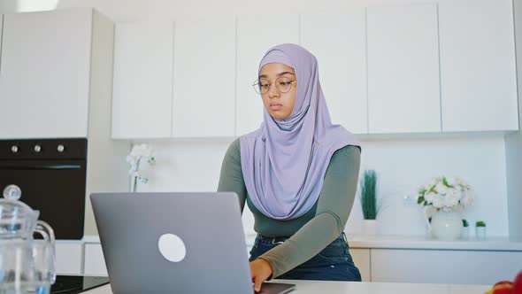 Portrait of Beautiful Muslim Woman Working in Home Office on Laptop Screen