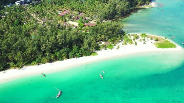 Aerial above seascape of paradise lagoon beach vacation by aqua blue water with white sand backgroun