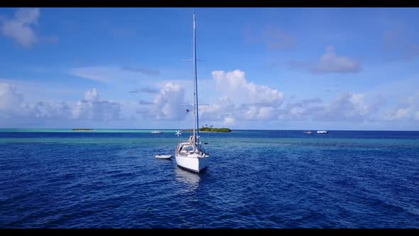 Aerial flying over landscape of beautiful coastline beach wildlife by blue ocean and white sandy bac