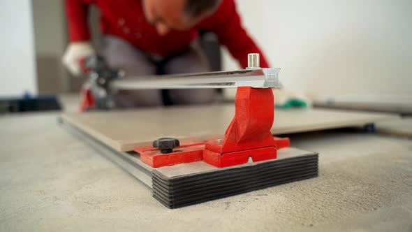 Master Cuts the Tile with a Tile Cutter