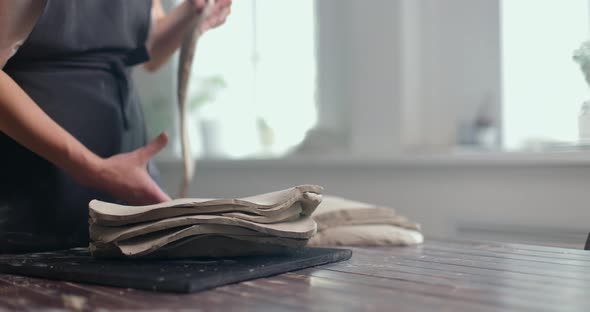 Female Potter Prepares the Material for Modeling Ceramics