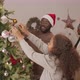 Happy Family of Three Decorating Christmas Tree - VideoHive Item for Sale