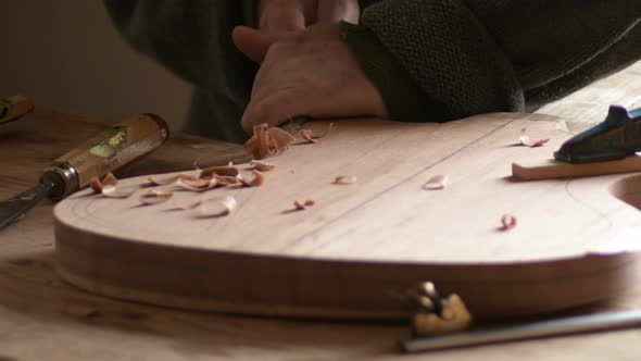 Luthier Manufacturing a New Guitar