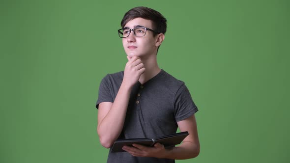 Young Handsome Iranian Teenage Boy Against Green Background