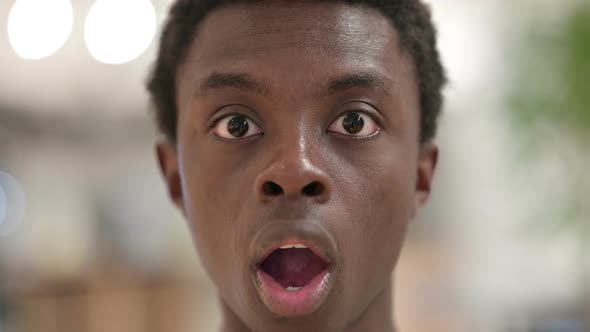 Close Up of Shocked Young African Man Face Wondering
