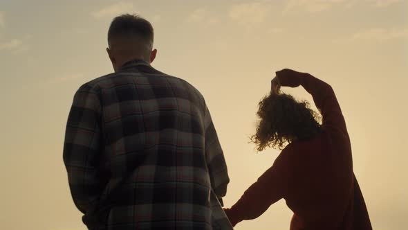 Couple Holding Hands on Beach